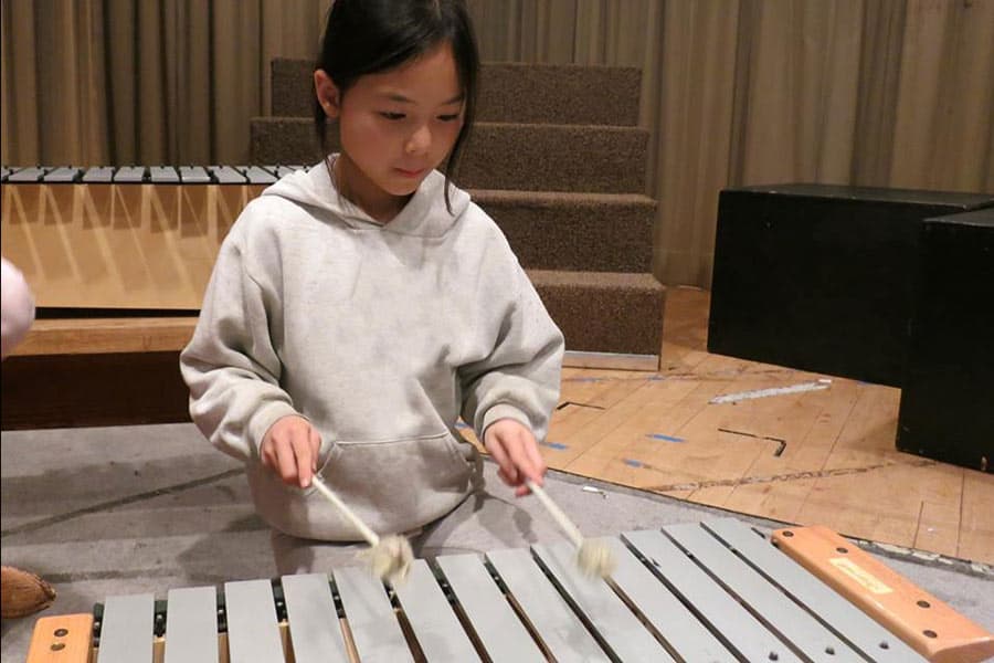 Elementary school kid playing xylophone