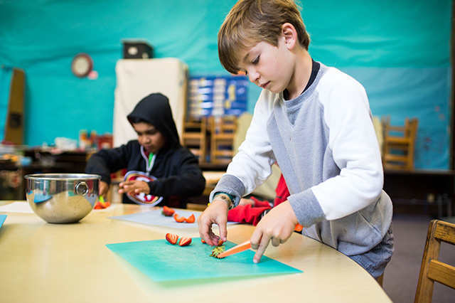 Elementary kids preparing food in after school enrichment class