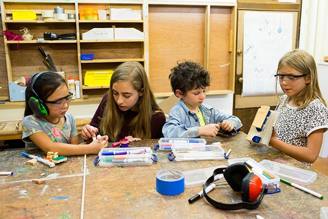 Kids of different ages working together in woodshop